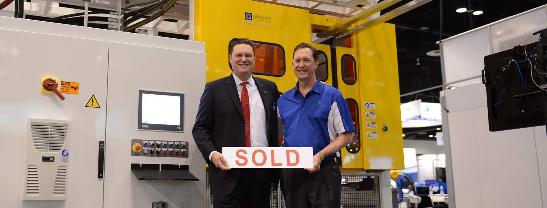 COO Patrick Lindsey with Graham CEO Dave Schroeder in front of a new mini Hercules