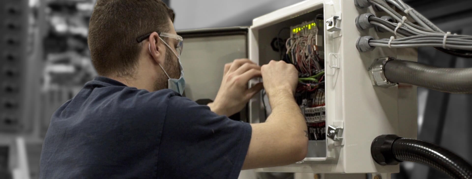 electrician testing a machine as part of solution design and parts and maintenance