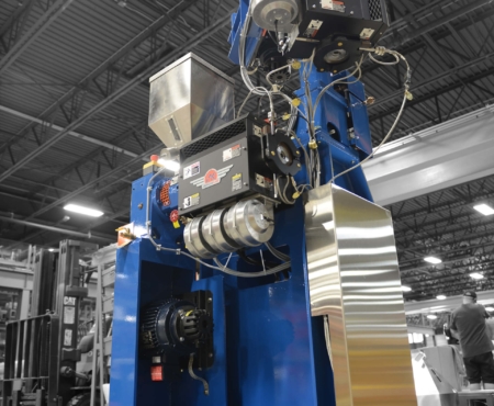 AKcent extruder in royal blue in a factory setting