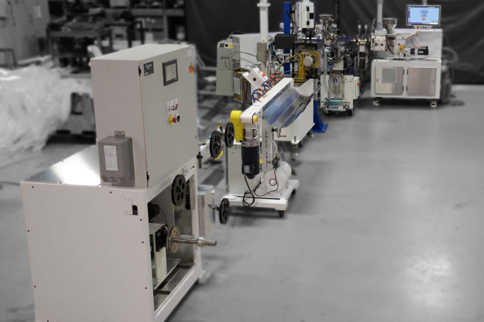 American Kuhne brand extrusion system shown in a factory setting.