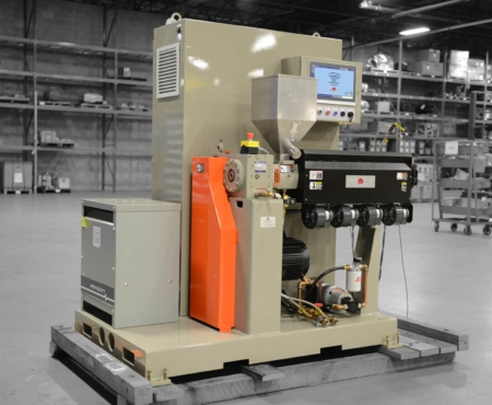 Ultra extruder pictured in grey-brown in a factory setting.