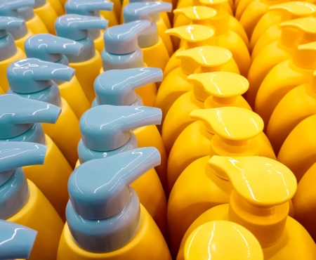 Yellow plastic bottles with yellow and gray caps showing consumer packaging markets and applications