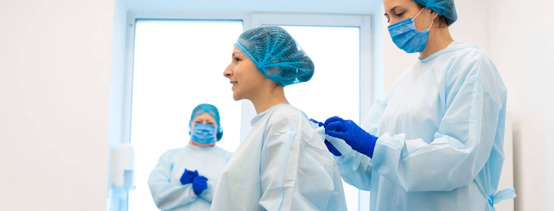 Medical industry shown with personnel in scrubs, gloves