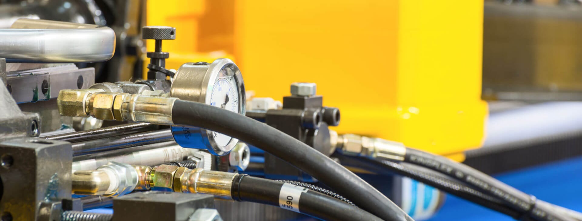 industrial tubing shown attached to a yellow and blue machine