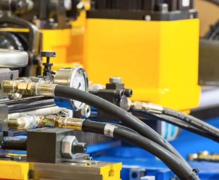 industrial tubing shown attached to a yellow and blue machine